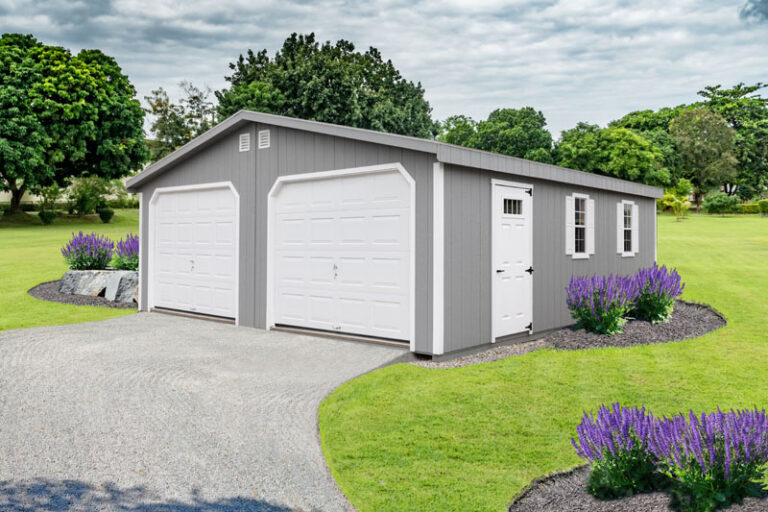 Gray and white 2 car prefab garage with landscaped lawn