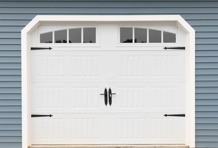 White overhead door garage door on blue wall.