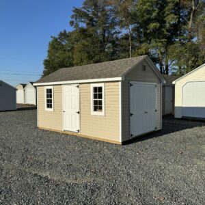 Tan and white storage shed for sale in Denton, MD