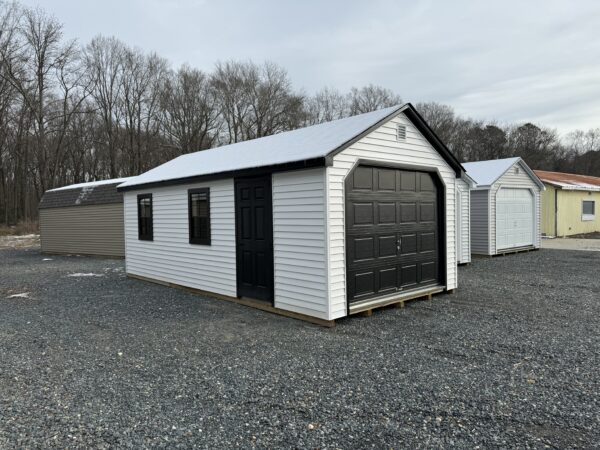 A white shed with black trim