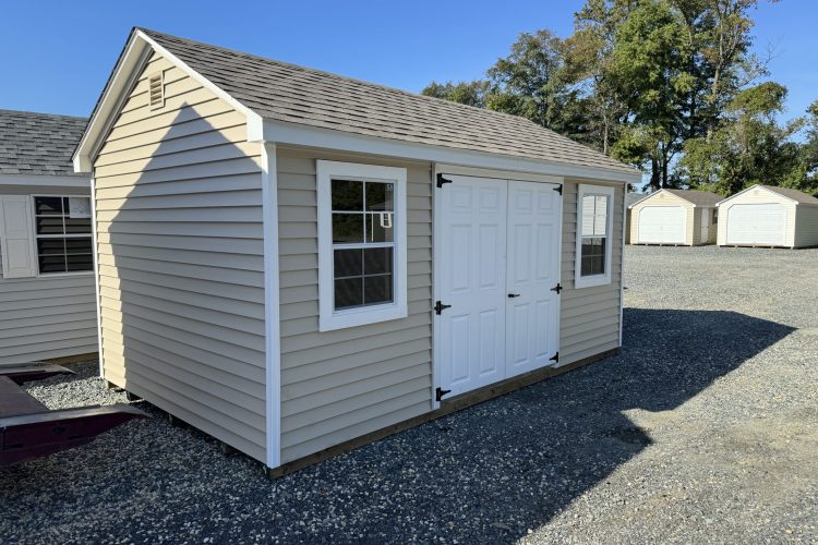 Tan and white storage shed for sale in Denton, MD